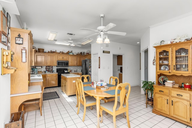 446 Marion Dr, Niceville, FL 32578 - dining space featuring light tile patterned floors, a ceiling fan, visible vents, and ornamental molding