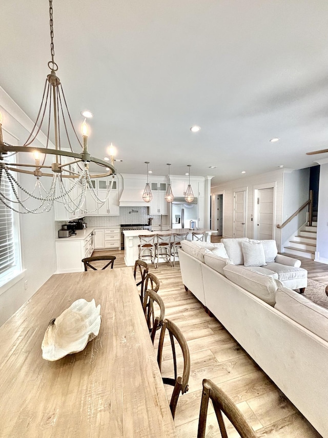 90 Montigo Ave, Santa Rosa Beach, FL 32459 - dining space featuring light wood-style floors, recessed lighting, and a chandelier