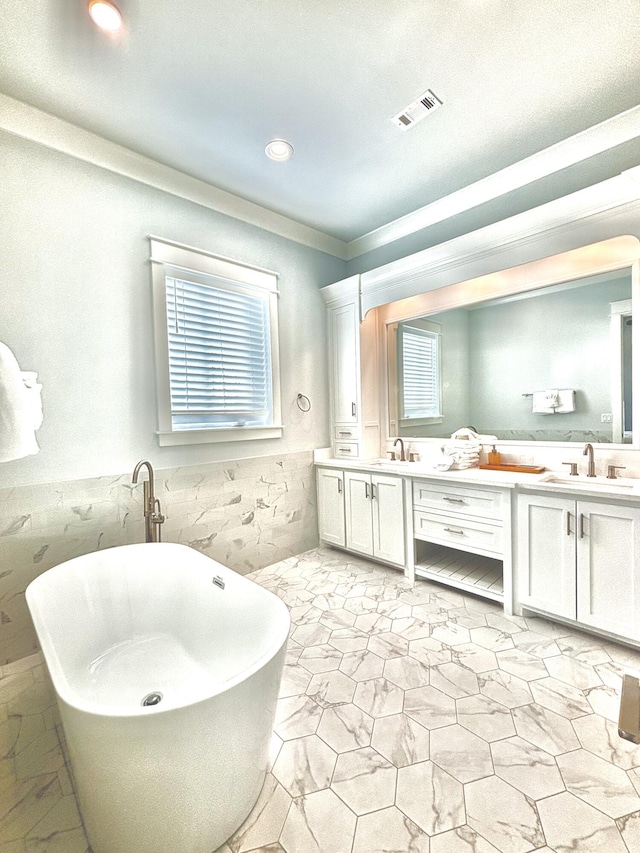 90 Montigo Ave, Santa Rosa Beach, FL 32459 - bathroom featuring double vanity, a freestanding bath, a wainscoted wall, crown molding, and recessed lighting