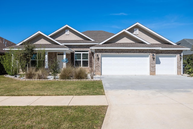 367 Brighton Cv, Freeport, FL 32439 - craftsman inspired home featuring an attached garage, concrete driveway, brick siding, a front lawn, and a shingled roof