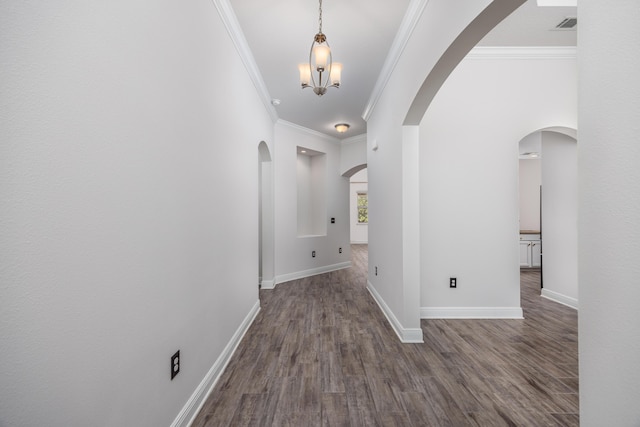 367 Brighton Cv, Freeport, FL 32439 - corridor featuring ornamental molding, arched walkways, dark wood-style floors, and baseboards