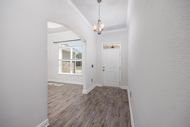 367 Brighton Cv, Freeport, FL 32439 - entryway featuring arched walkways, dark wood-style floors, ornamental molding, and baseboards
