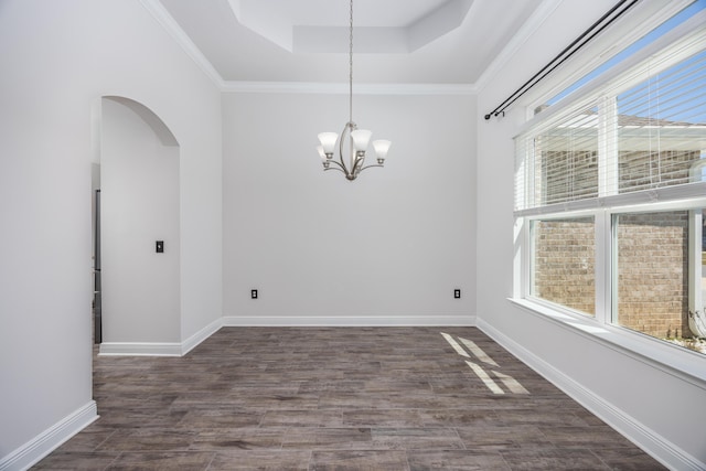367 Brighton Cv, Freeport, FL 32439 - unfurnished dining area with a tray ceiling, an inviting chandelier, baseboards, arched walkways, and dark wood-style floors
