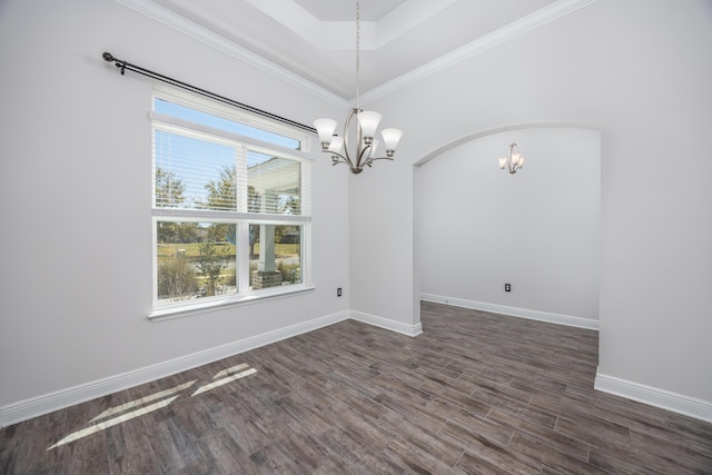 367 Brighton Cv, Freeport, FL 32439 - unfurnished room with crown molding, a chandelier, dark wood-style floors, baseboards, and arched walkways