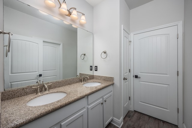 367 Brighton Cv, Freeport, FL 32439 - full bath featuring double vanity, a sink, and wood finished floors