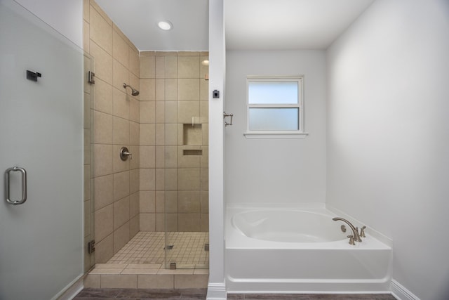 367 Brighton Cv, Freeport, FL 32439 - bathroom featuring a stall shower, baseboards, and a bath