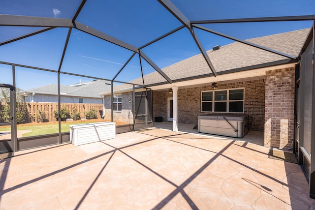 367 Brighton Cv, Freeport, FL 32439 - view of patio / terrace with a ceiling fan, fence, glass enclosure, and a hot tub