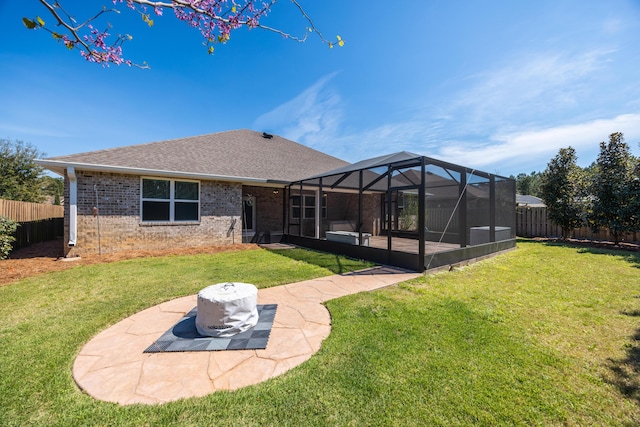 367 Brighton Cv, Freeport, FL 32439 - back of house featuring a lanai, a patio, a fenced backyard, brick siding, and a lawn