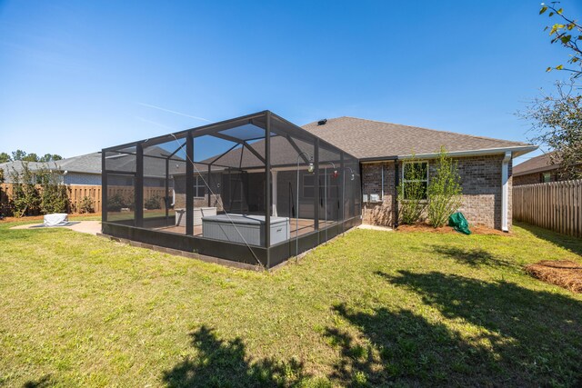 367 Brighton Cv, Freeport, FL 32439 - rear view of house with a fenced backyard, brick siding, a lanai, and a lawn