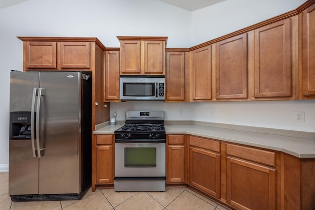 kitchen featuring appliances with stainless steel finishes and brown cabinets