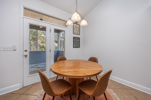 dining room with baseboards, vaulted ceiling, an inviting chandelier, and light tile patterned floors