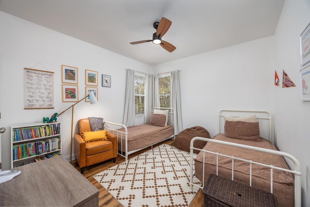 bedroom featuring wood finished floors and a ceiling fan