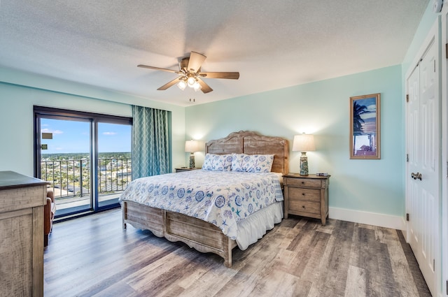 6201 Thomas Dr Unit 1510, Panama City Beach, FL 32408 - bedroom featuring wood finished floors, a textured ceiling, access to outside, baseboards, and ceiling fan
