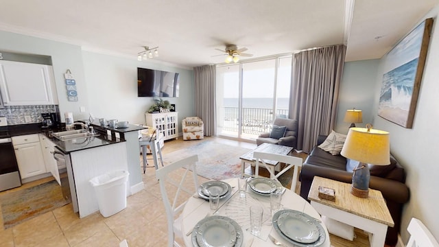 16819 Front Beach Rd Unit 210, Panama City Beach, FL 32413 - kitchen featuring a peninsula, open floor plan, a sink, dark countertops, and ceiling fan