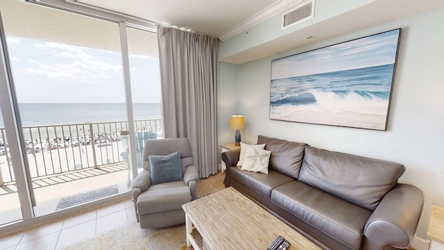 16819 Front Beach Rd Unit 210, Panama City Beach, FL 32413 - living room with view of water and beach, tile patterned flooring, ornamental molding, and floor to ceiling windows