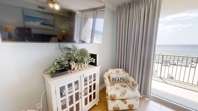 16819 Front Beach Rd Unit 210, Panama City Beach, FL 32413 - sitting room featuring tile patterned floors, a water view, and a ceiling fan