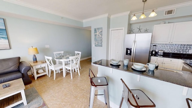 16819 Front Beach Rd Unit 210, Panama City Beach, FL 32413 - kitchen featuring stainless steel fridge with ice dispenser, ornamental molding, a kitchen bar, white cabinetry, and pendant lighting