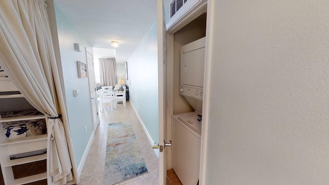 16819 Front Beach Rd Unit 210, Panama City Beach, FL 32413 - hallway featuring estacked washer and dryer, light tile patterned floors, and baseboards
