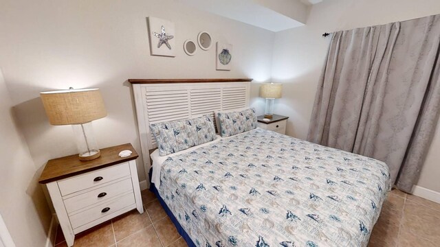 16819 Front Beach Rd Unit 210, Panama City Beach, FL 32413 - tiled bedroom featuring baseboards
