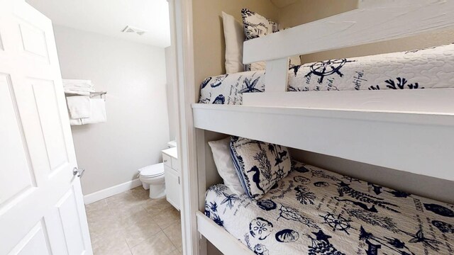 16819 Front Beach Rd Unit 210, Panama City Beach, FL 32413 - bathroom featuring baseboards, tile patterned flooring, toilet, and vanity