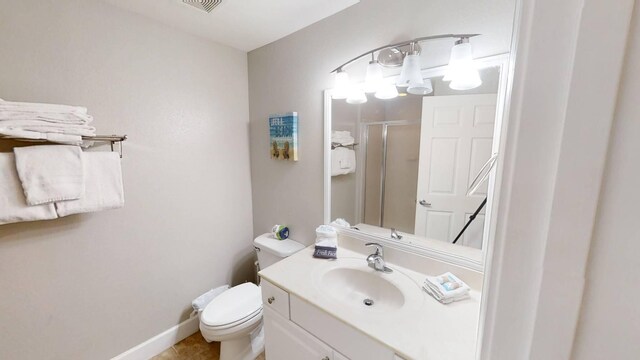 16819 Front Beach Rd Unit 210, Panama City Beach, FL 32413 - bathroom featuring a stall shower, vanity, toilet, tile patterned floors, and baseboards
