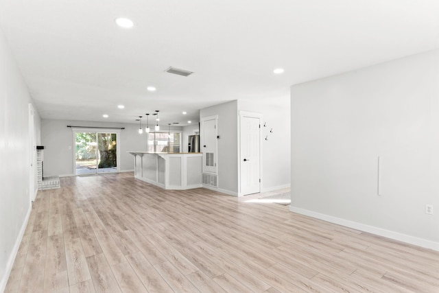 unfurnished living room featuring recessed lighting, visible vents, baseboards, and light wood finished floors