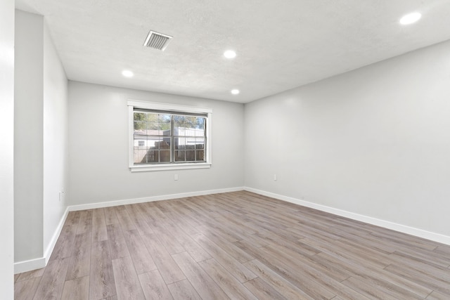 unfurnished room with recessed lighting, visible vents, baseboards, and light wood-style flooring