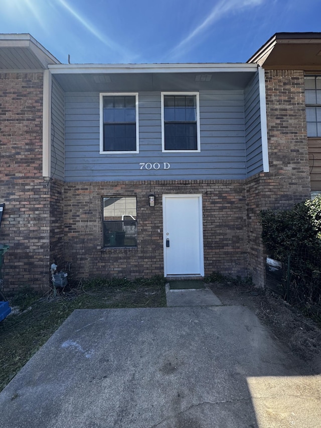 entrance to property with brick siding