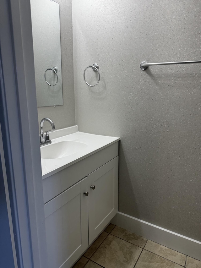 bathroom featuring vanity, tile patterned floors, and baseboards