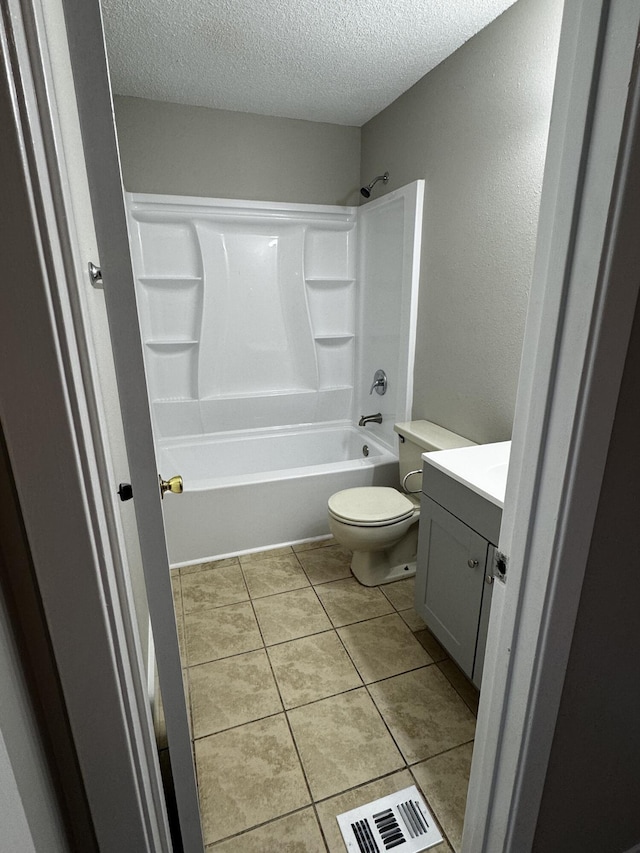 bathroom with vanity, visible vents, a textured ceiling, tile patterned floors, and toilet