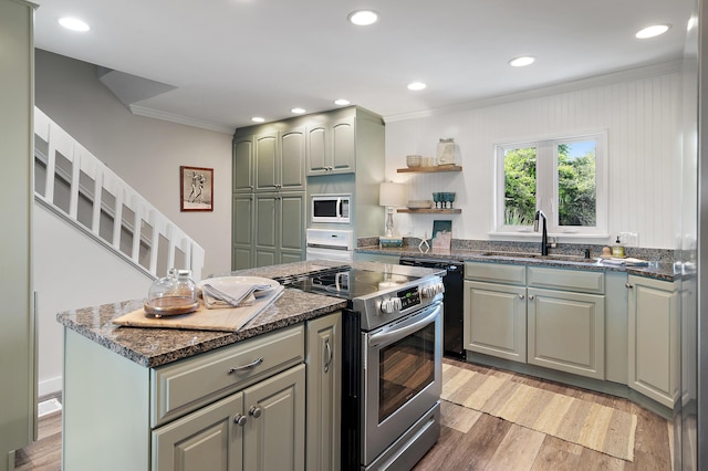 2381 W County Highway 30a Unit 8, Santa Rosa Beach, FL 32459 - kitchen with white appliances, ornamental molding, light wood-style floors, dark stone counters, and a kitchen island