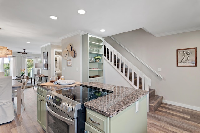 2381 W County Highway 30a Unit 8, Santa Rosa Beach, FL 32459 - kitchen with stainless steel electric range oven, green cabinets, ornamental molding, recessed lighting, and light wood-type flooring