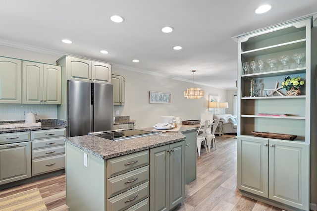 2381 W County Highway 30a Unit 8, Santa Rosa Beach, FL 32459 - kitchen with freestanding refrigerator, crown molding, a kitchen island, electric stovetop, and pendant lighting