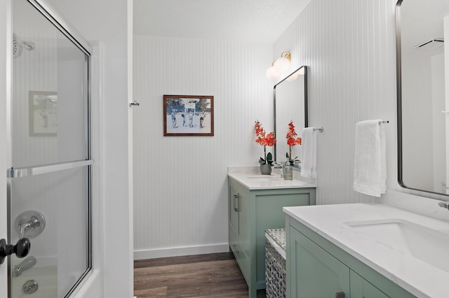 2381 W County Highway 30a Unit 8, Santa Rosa Beach, FL 32459 - bathroom featuring wood finished floors, vanity, and bath / shower combo with glass door