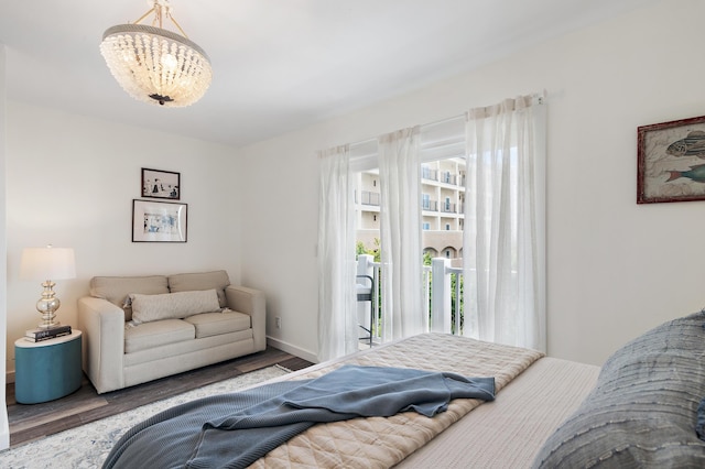2381 W County Highway 30a Unit 8, Santa Rosa Beach, FL 32459 - bedroom with wood finished floors, a chandelier, and access to outside