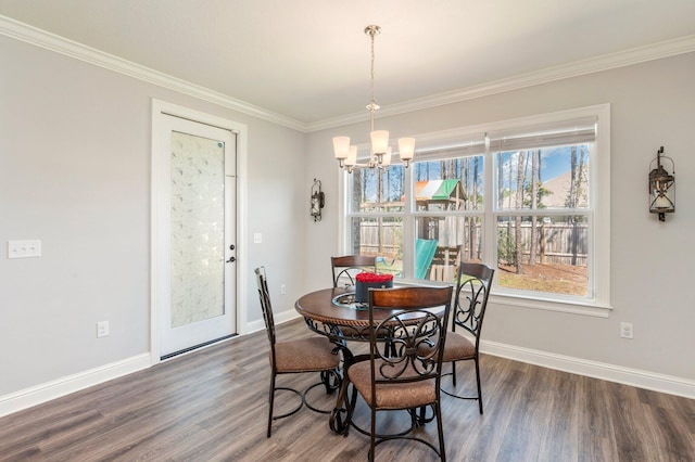dining area with a notable chandelier, wood finished floors, baseboards, and ornamental molding