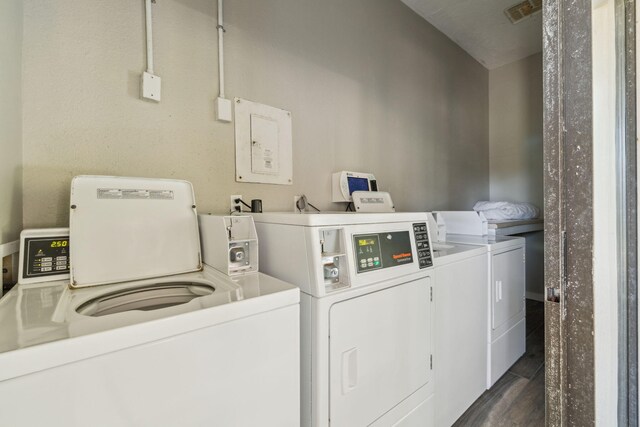 145 Beachfront Trl Unit 102A, Santa Rosa Beach, FL 32459 - community laundry room featuring separate washer and dryer, dark wood-style flooring, and visible vents