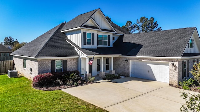view of front of property with brick siding, board and batten siding, a front yard, driveway, and an attached garage