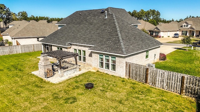 back of house featuring a patio, roof with shingles, a fenced backyard, a lawn, and a residential view