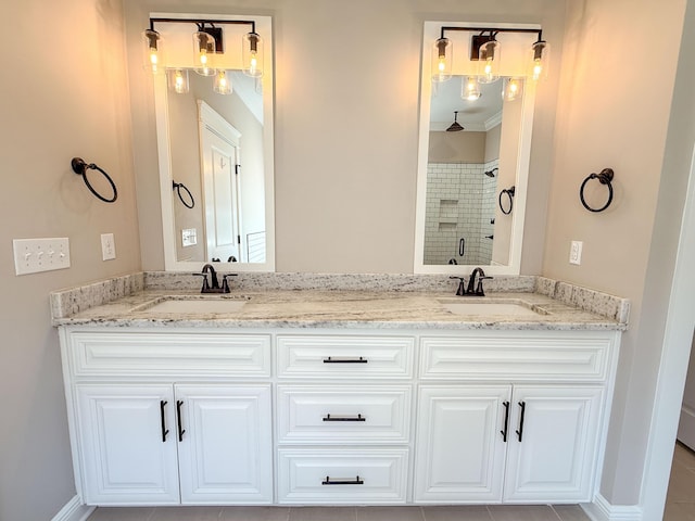 bathroom featuring a shower stall, double vanity, and a sink