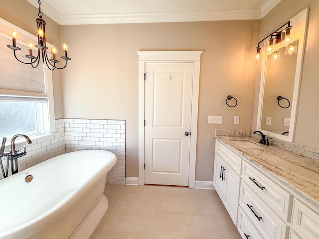 bathroom featuring a soaking tub, a notable chandelier, vanity, and crown molding