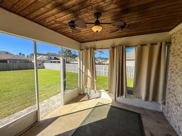 unfurnished sunroom featuring ceiling fan