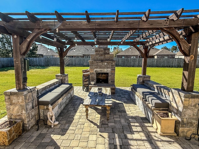 view of patio / terrace with an outdoor stone fireplace, a fenced backyard, and a pergola