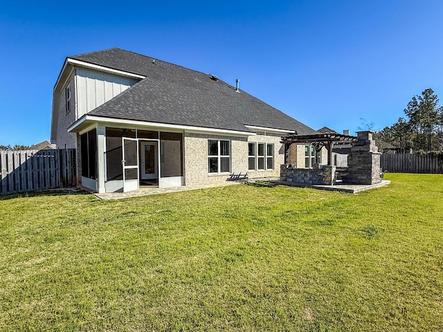 rear view of property with a fenced backyard, a pergola, a sunroom, a shingled roof, and a lawn