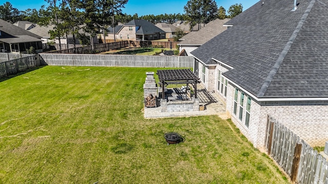 view of yard featuring a garage, a residential view, and a fenced backyard