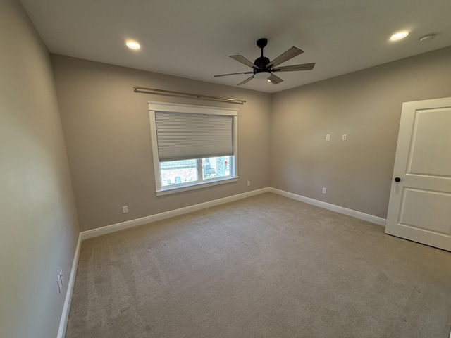 spare room with recessed lighting, a ceiling fan, baseboards, and light carpet
