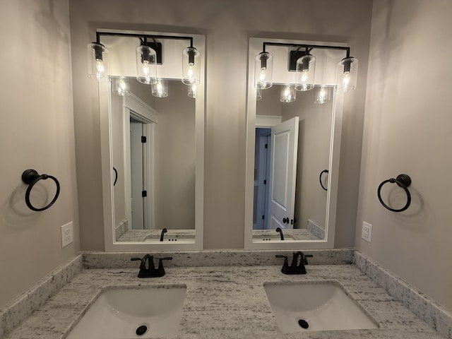 full bathroom featuring a sink and double vanity