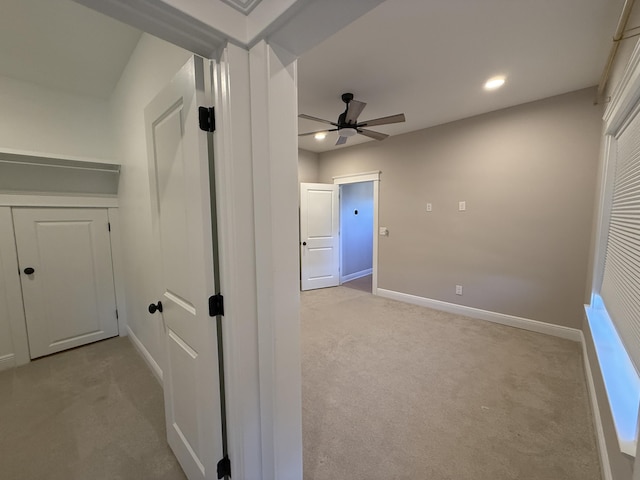hallway featuring recessed lighting, baseboards, and light carpet