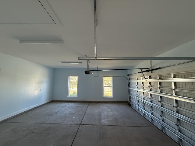 garage with a garage door opener and baseboards