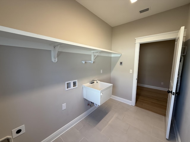 clothes washing area featuring visible vents, baseboards, washer hookup, laundry area, and hookup for an electric dryer